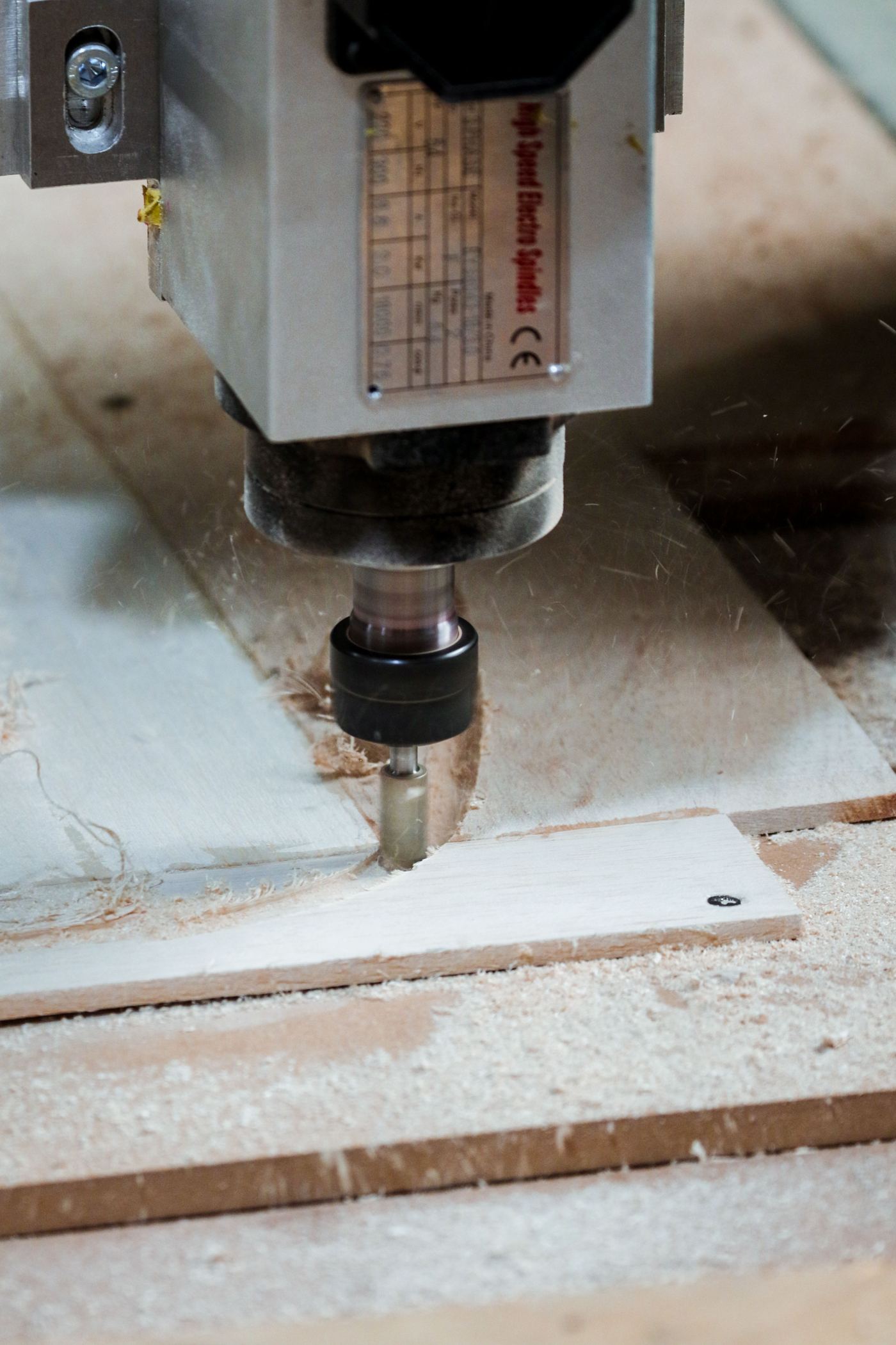 CNC router cutting a wooden panel